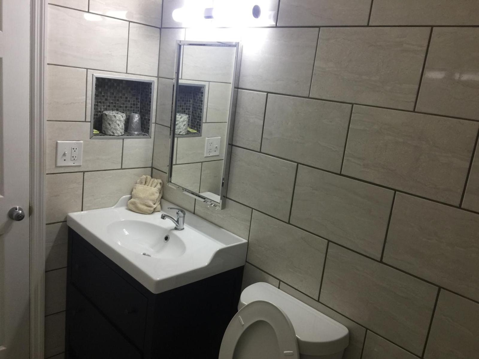 Flamingo Inn Sarasota guest bathroom with sink and mirror
