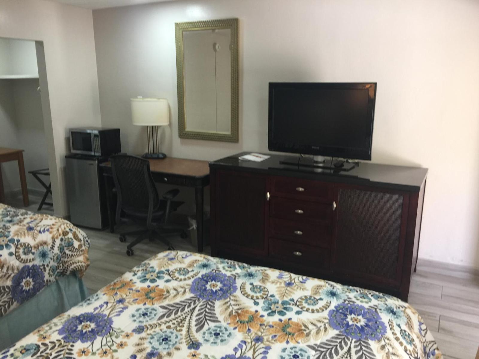 Guest room television, refrigerator, microwave and work area